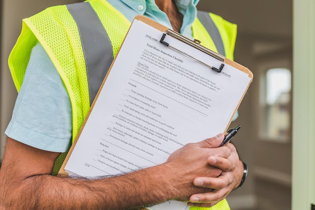 A person holding a home inspection checklist.