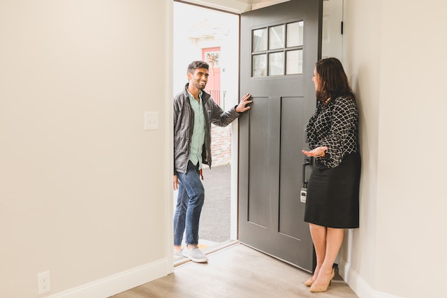 A landlord being welcomed into their tenant’s home.