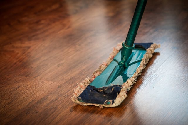 A hardwood floor being swept.